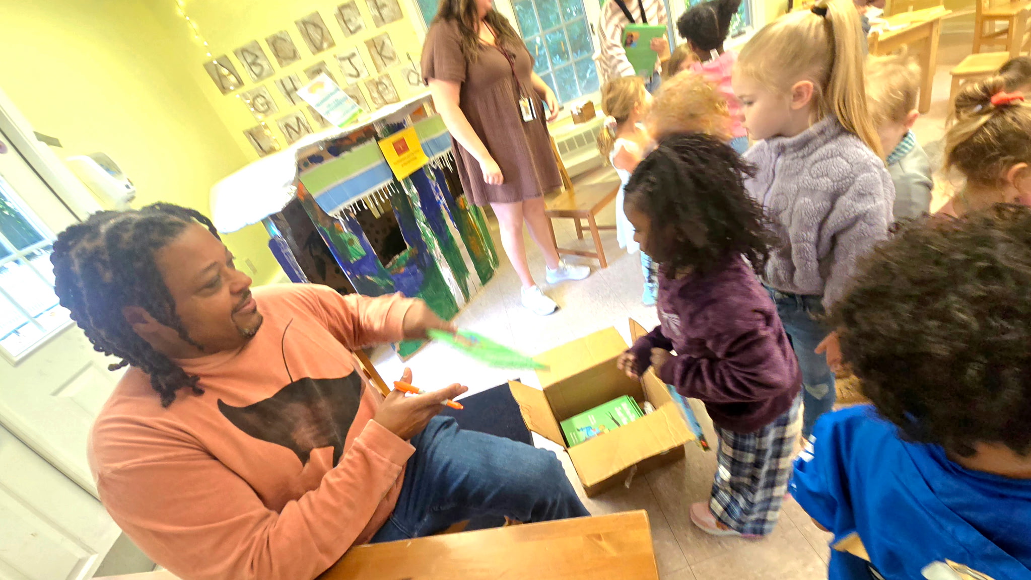 Rod Cornish signing and gifting books to children from a box