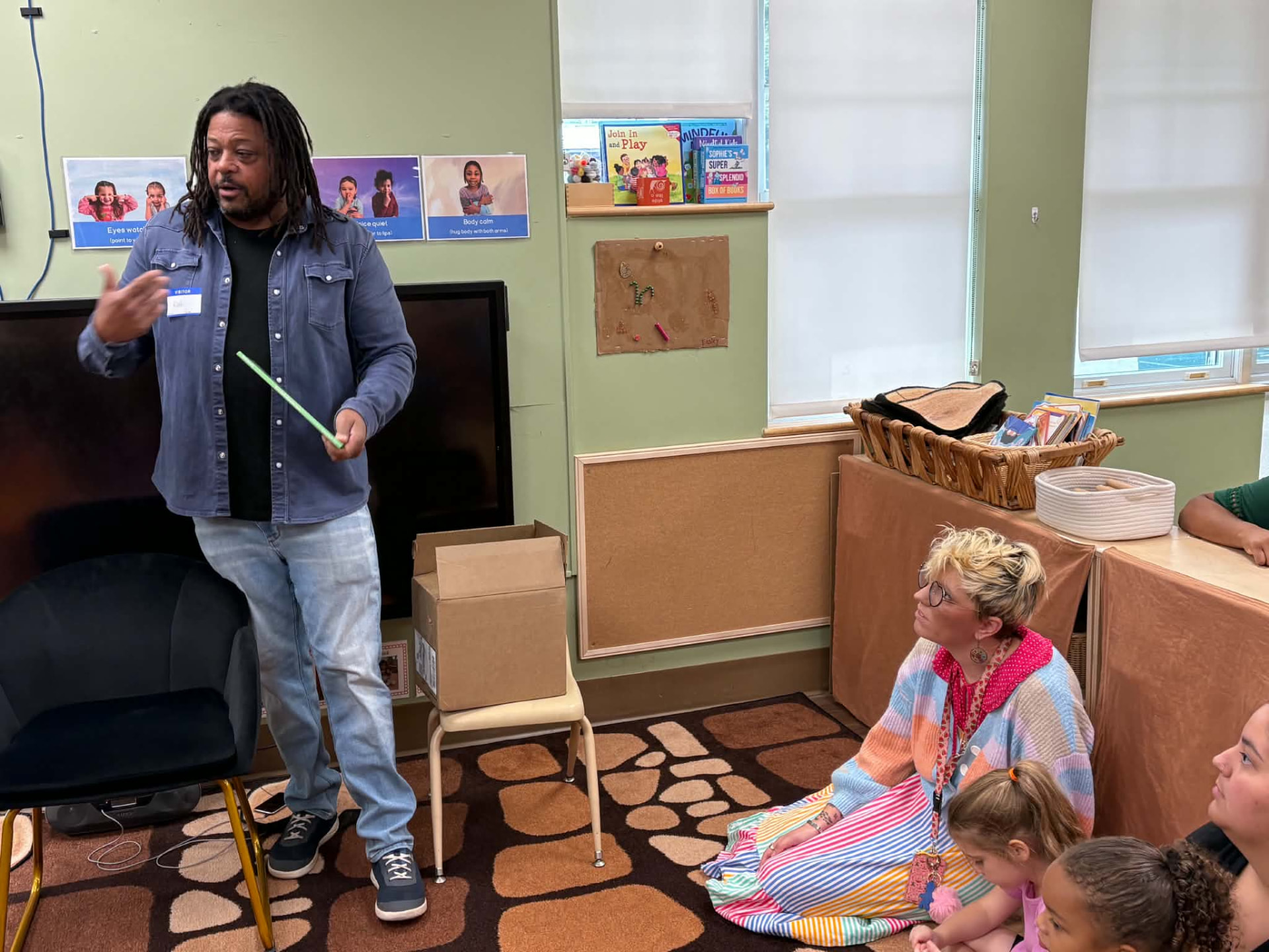 Rod Cornish talking with a teacher during a classroom visit